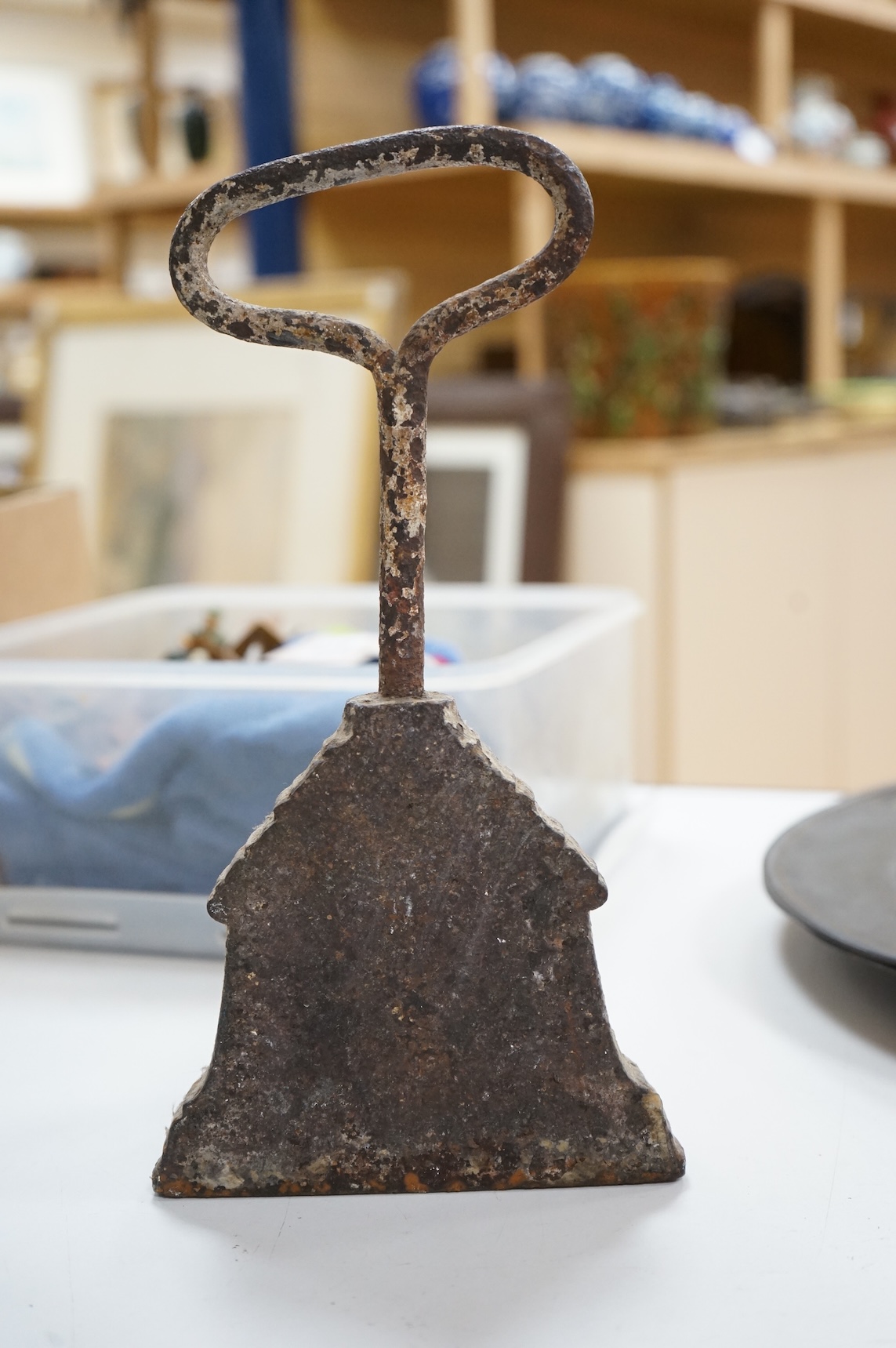 A 19th century cast iron bell shaped door stop, 29cm high